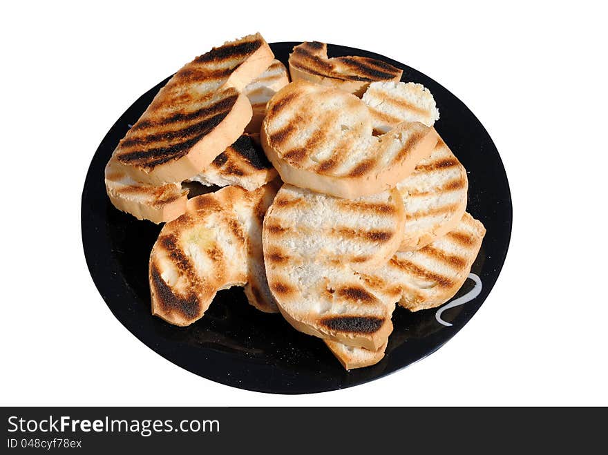 Grilled slices of bread on a dish isolated on white background