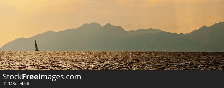 Lonely yacht on the background of the mountains