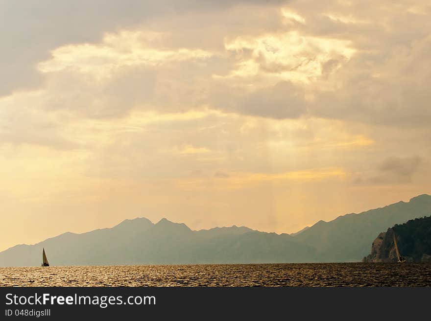 Lonely yacht on the background of the mountains