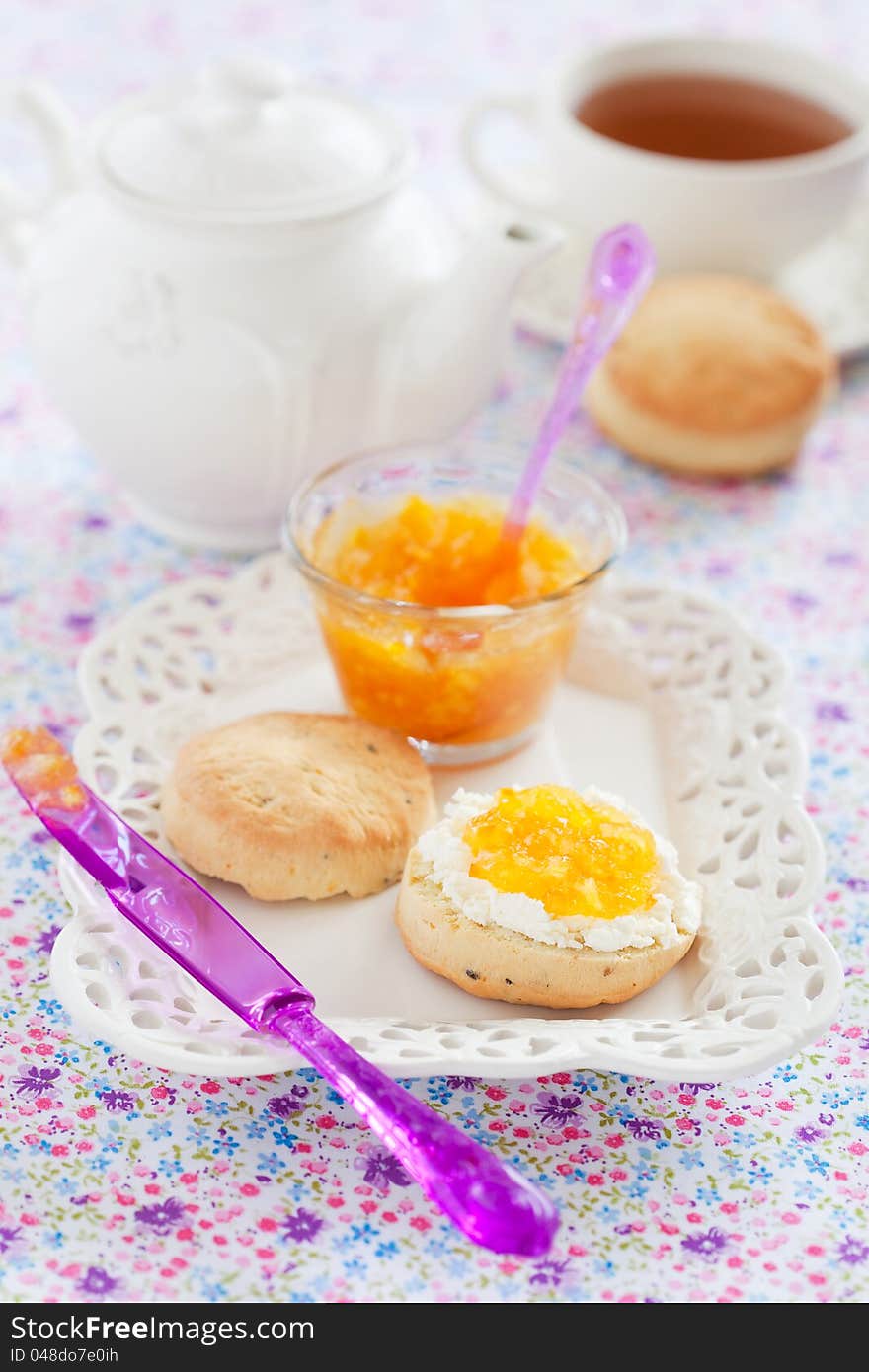 Orange scones with lavender, served with fresh cheese and orange jam, selective focus