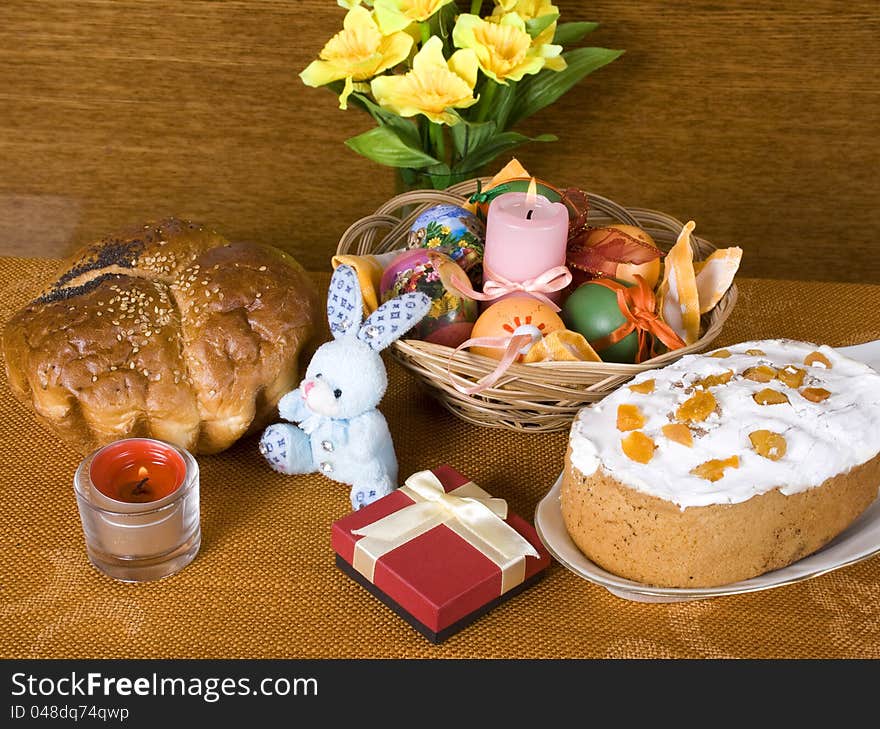 Holiday Arrangement to Easter. Easter bread, gift, rabbit and colored eggs