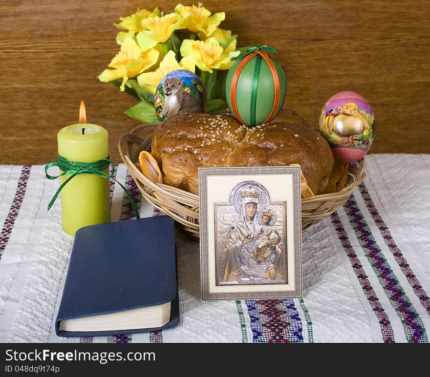 Lighted candle, Easter bread and colored eggs icon and the Bible. Lighted candle, Easter bread and colored eggs icon and the Bible