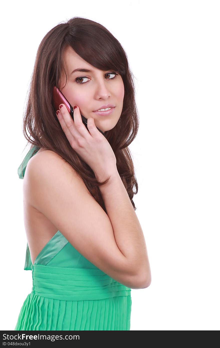 Pretty young woman dressed in green speaking at the phone. Pretty young woman dressed in green speaking at the phone