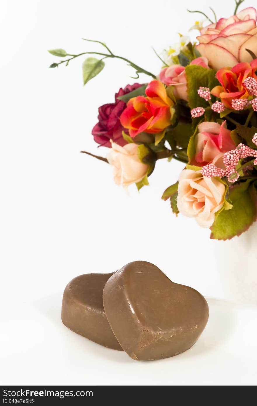 Chocolate heart and rose in the Valentine's Day, white background. Chocolate heart and rose in the Valentine's Day, white background