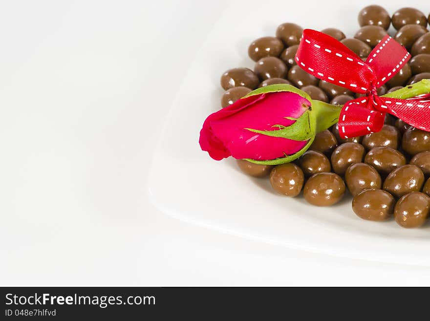 Chocolate and rose in the Valentine's Day on white background. Chocolate and rose in the Valentine's Day on white background