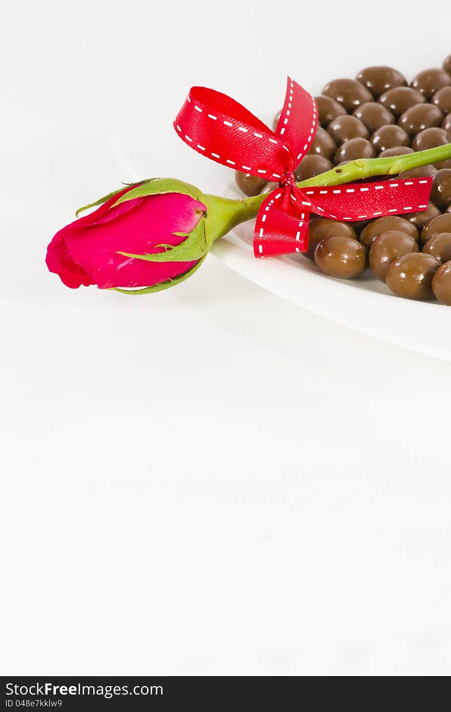 Chocolate and rose in the Valentine's Day on white background. Chocolate and rose in the Valentine's Day on white background