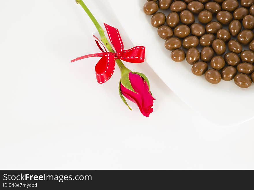 Chocolate and rose in the Valentine's Day on white background. Chocolate and rose in the Valentine's Day on white background