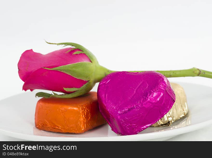 Chocolate heart and rose in the Valentine's Day, white background. Chocolate heart and rose in the Valentine's Day, white background