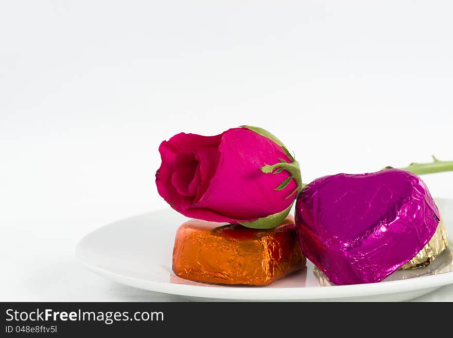 Chocolate heart and rose in the Valentine's Day, white background. Chocolate heart and rose in the Valentine's Day, white background