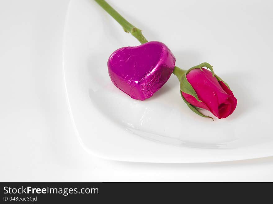 Chocolate heart and rose in the Valentine's Day, White background. Chocolate heart and rose in the Valentine's Day, White background