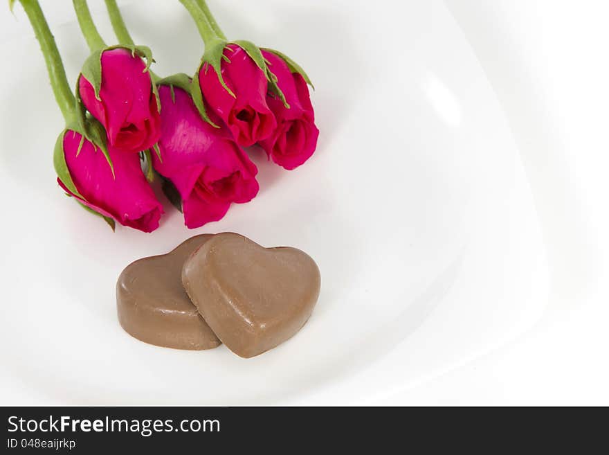 Chocolate heart and rose in the Valentine's Day, white background. Chocolate heart and rose in the Valentine's Day, white background