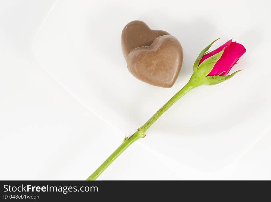 Chocolate heart and rose in the Valentine's Day, white background. Chocolate heart and rose in the Valentine's Day, white background