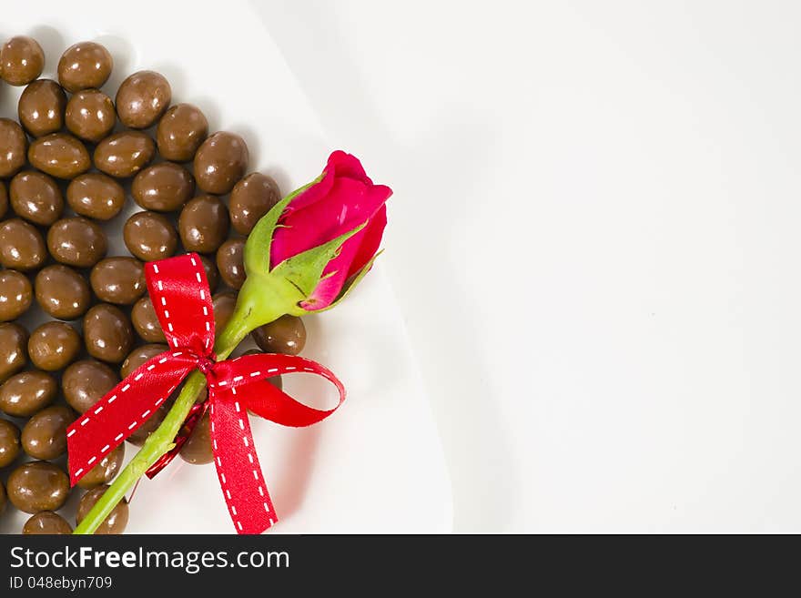 Chocolate heart and rose in the Valentine's Day on white background. Chocolate heart and rose in the Valentine's Day on white background