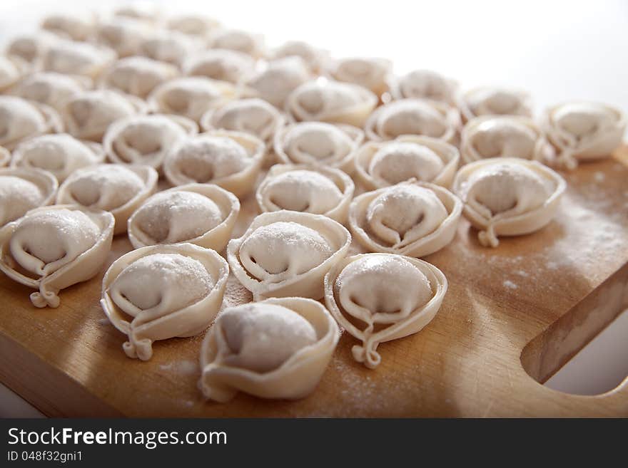 Some raw dumplings on the wooden board