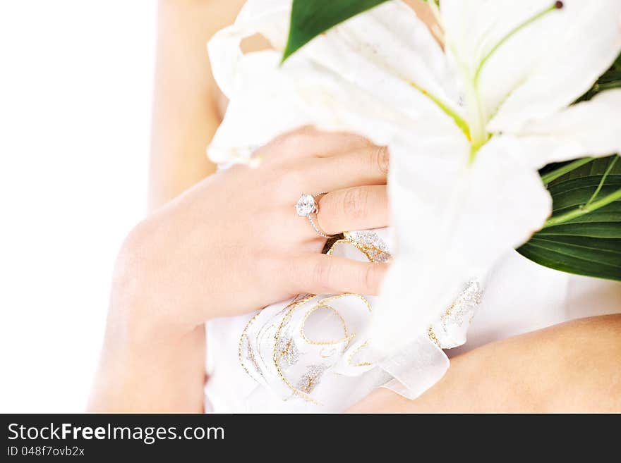 Hand of a bride with ring and flowers