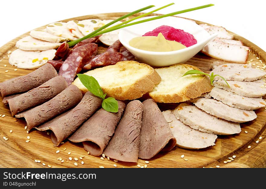 Wooden plate with sausage on a white background. Wooden plate with sausage on a white background