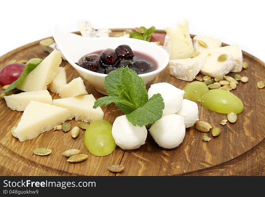 Dish with cheese sauce and decorated with nuts and grapes. Dish with cheese sauce and decorated with nuts and grapes