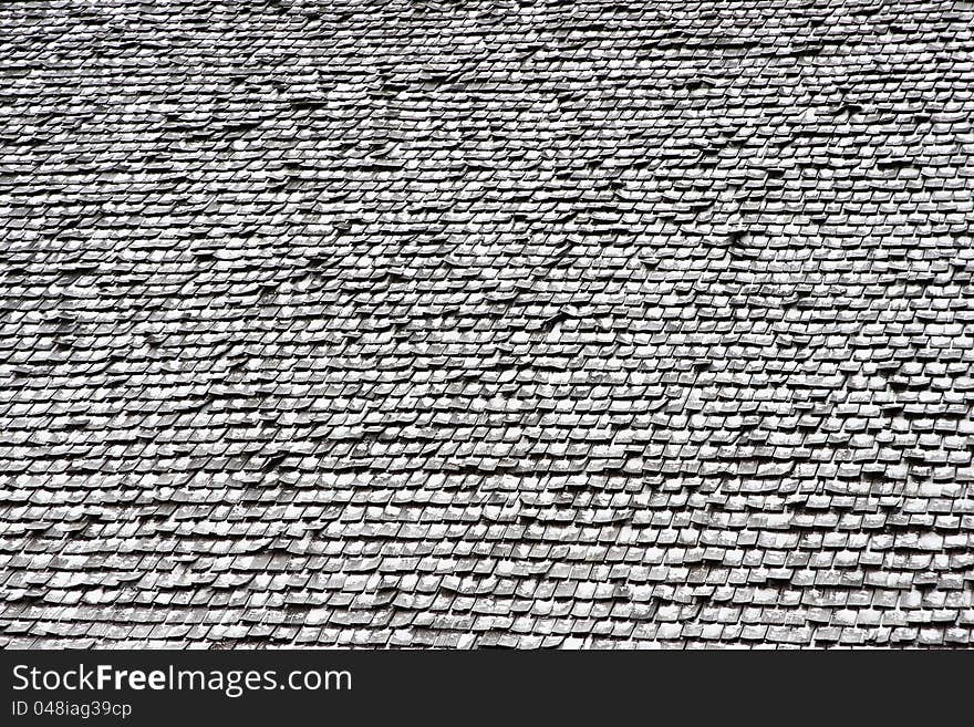 Wooden shingles on roof with snow