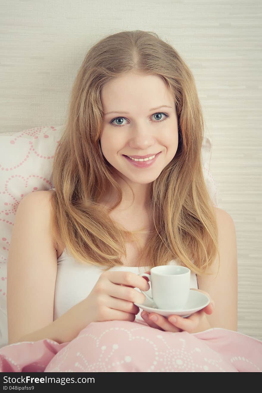 Beautiful young woman with cup of  coffee