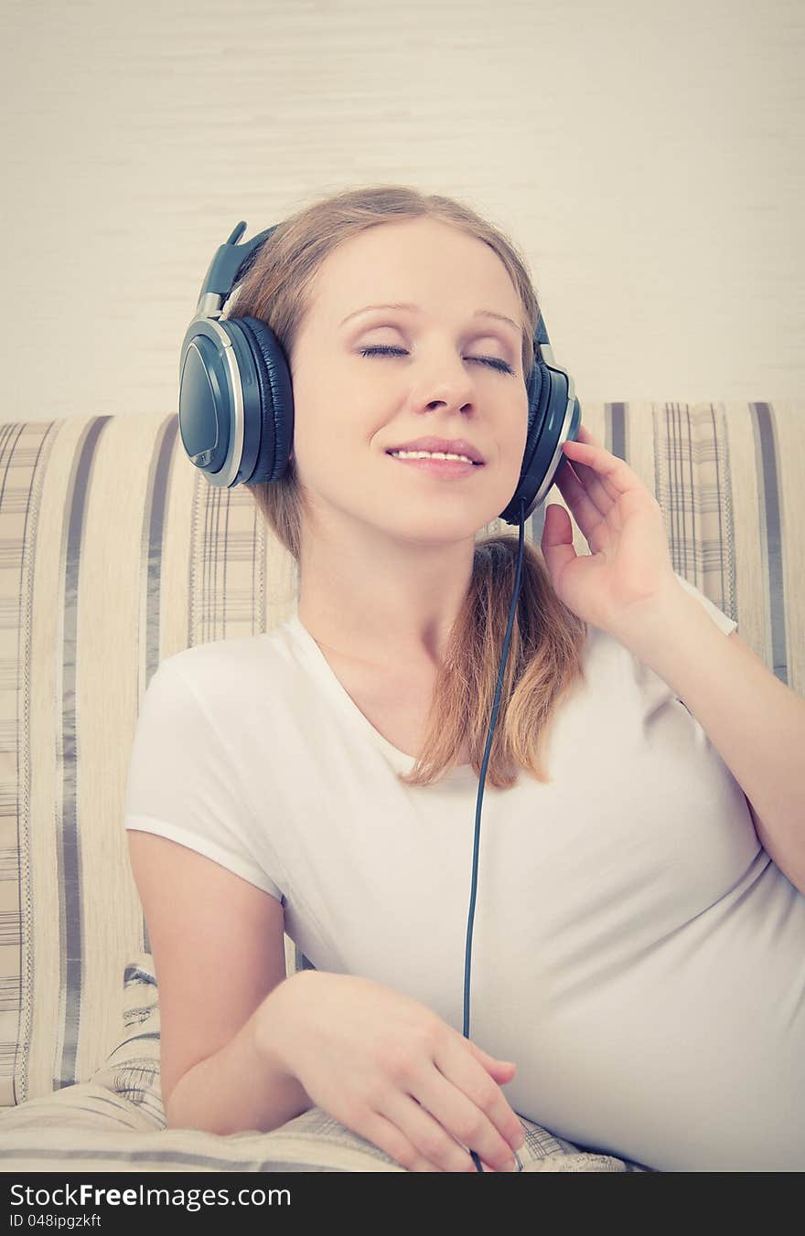 Beautiful young woman listening to music