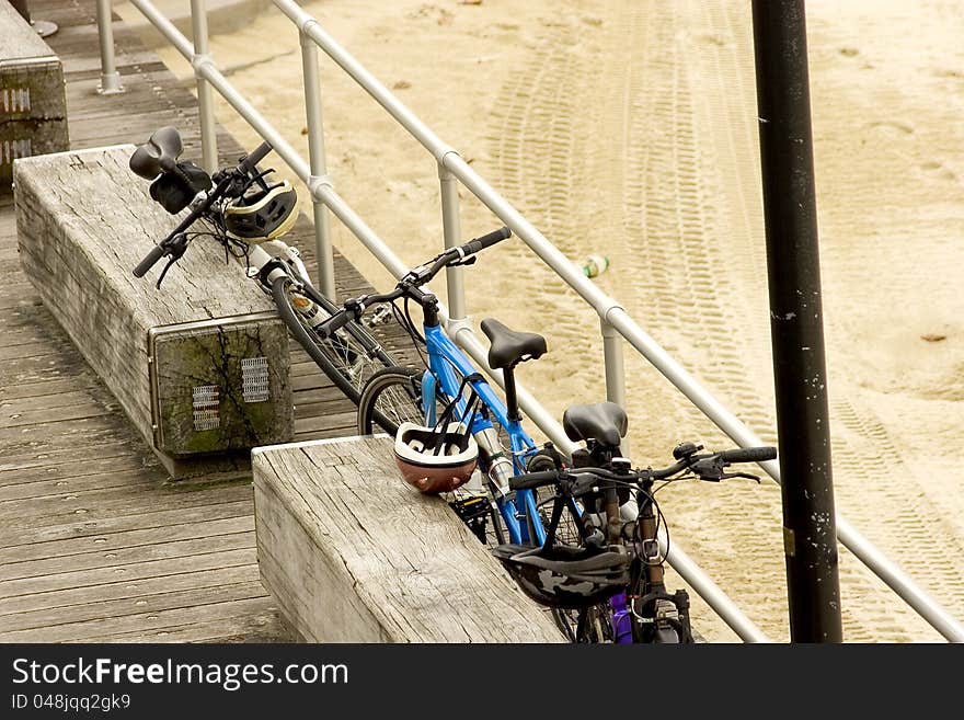 Three parked pushbikes at beach.