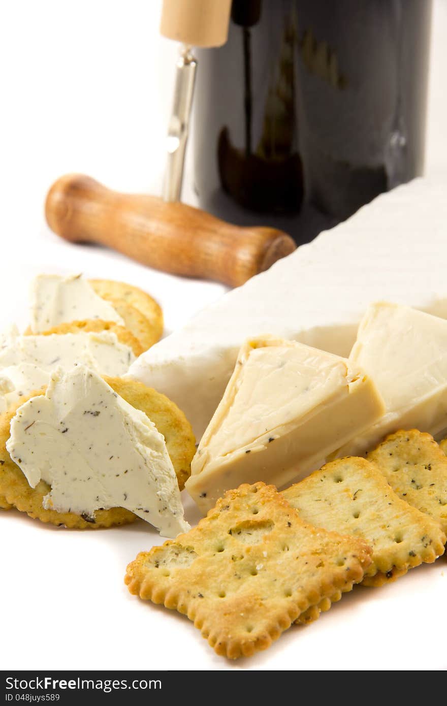 Picture of brie, cheese, crackers and a bottle of red wine. Picture of brie, cheese, crackers and a bottle of red wine