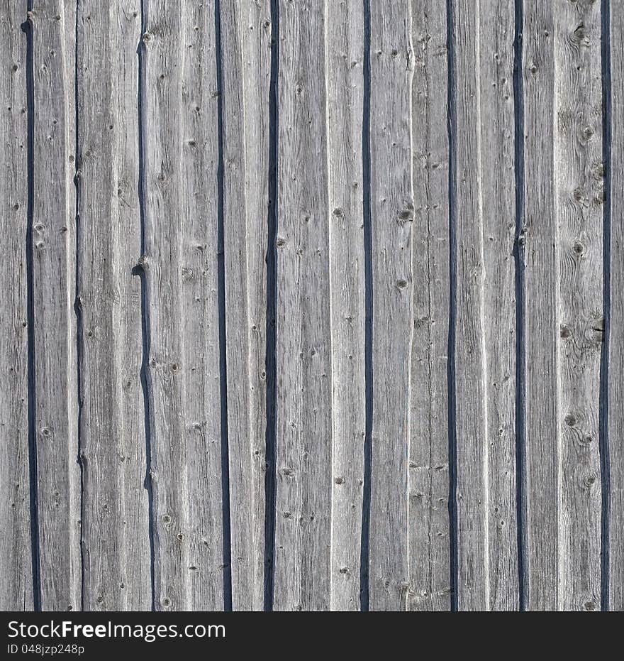 Background of old gray weathered knotted wooden wall