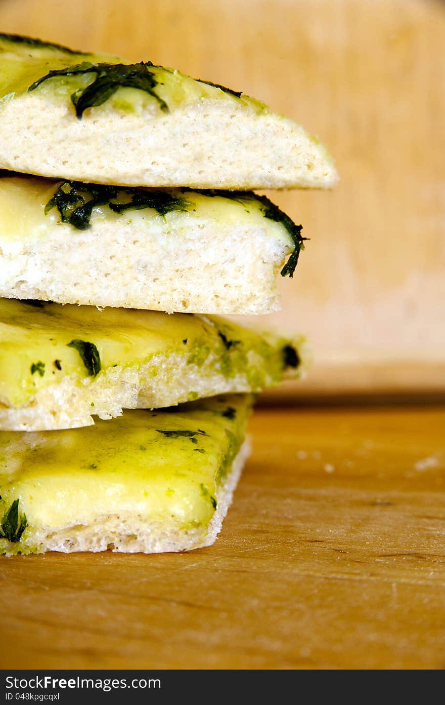 Focaccia - traditional Italian food with mozarella and basil paste. Pile of italian bread pices. Focaccia - traditional Italian food with mozarella and basil paste. Pile of italian bread pices.