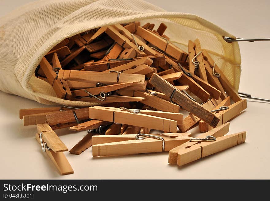 A closeup view of a clothespin bag on a white background. A closeup view of a clothespin bag on a white background.