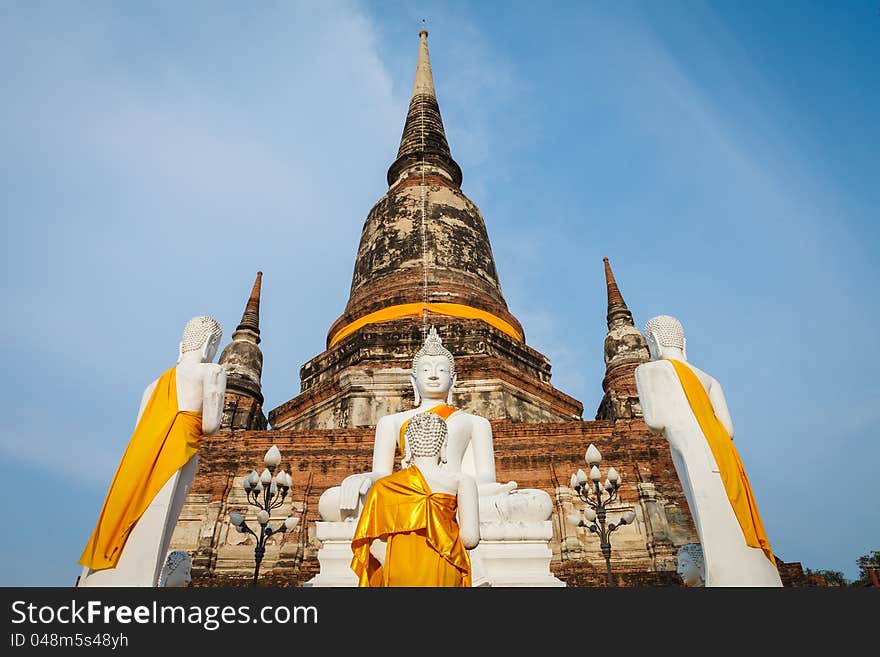 White buddha statue in front of ancient pagoda in Ayuthaya, Thailand