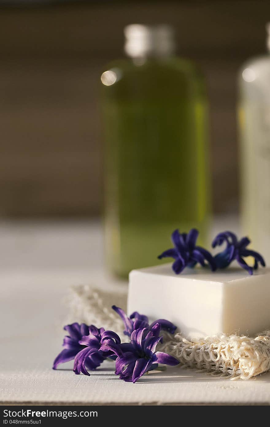 Soap and body lotion on a wooden table. Soap and body lotion on a wooden table