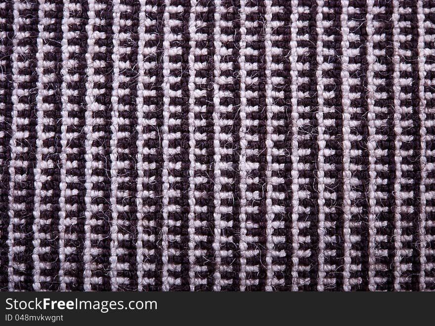 Fragment of the knitted natural dark fabric. Fragment of the knitted natural dark fabric