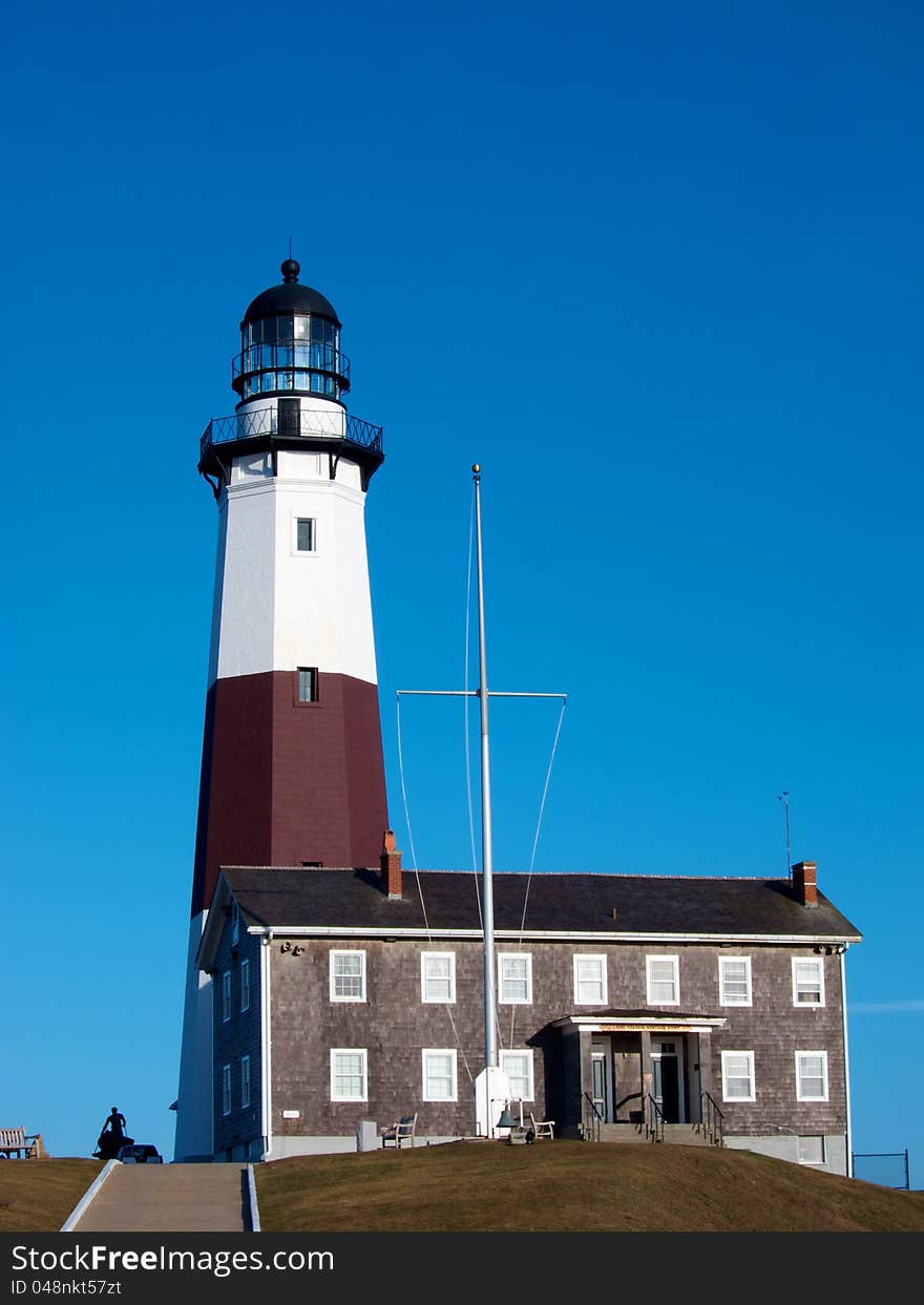 The lighthouse at Montauk Point, Long Island, is shown on a sunny day with a brilliant blue sky. The lighthouse at Montauk Point, Long Island, is shown on a sunny day with a brilliant blue sky.