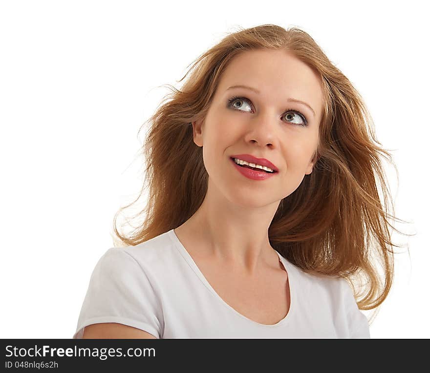 Beautiful young woman with flowing hair looks up at the empty space an isolated on white background