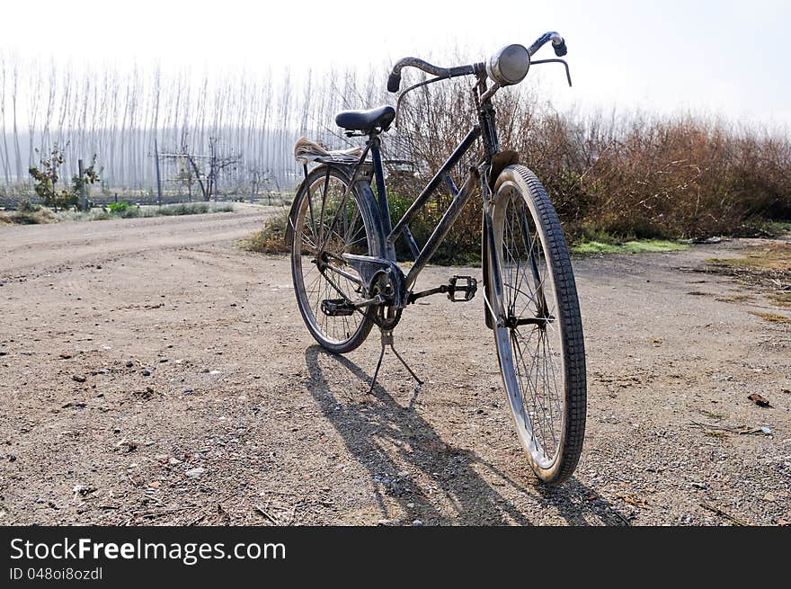 Photograph a big old bicycle in the rural environment