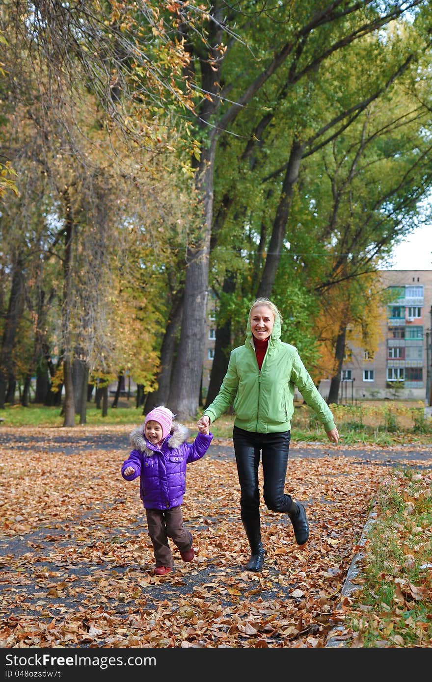 Woman  with her daughter in the autumn park