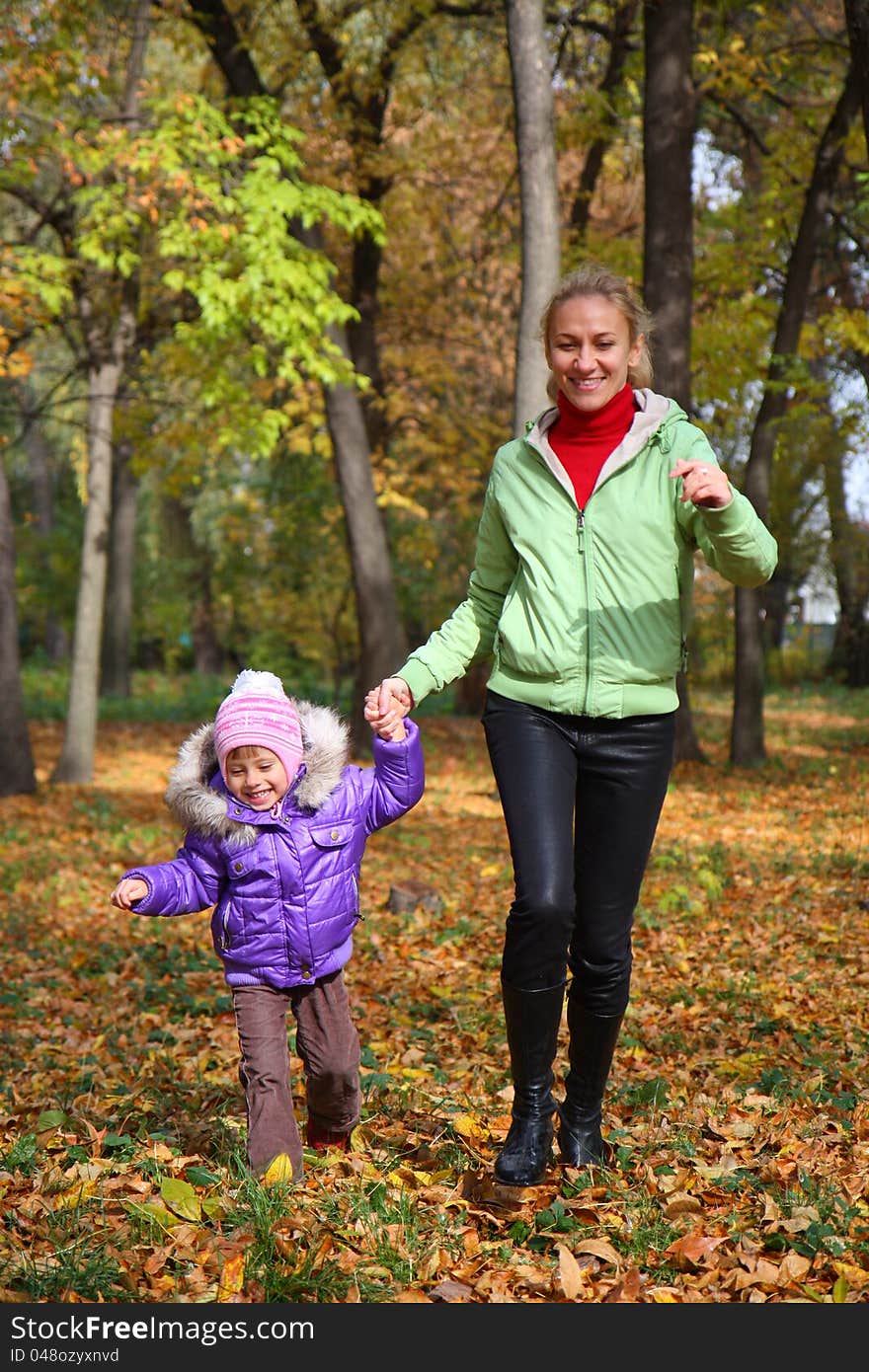 Woman  With Her Daughter In The Autumn Park