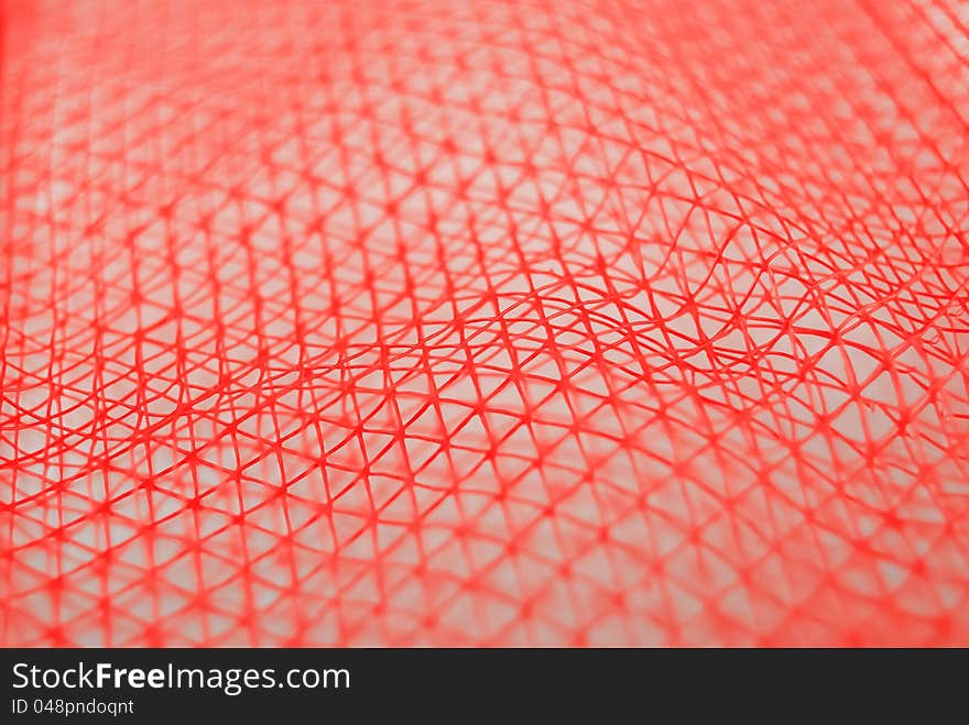 A piece of red nylon net. A piece of red nylon net