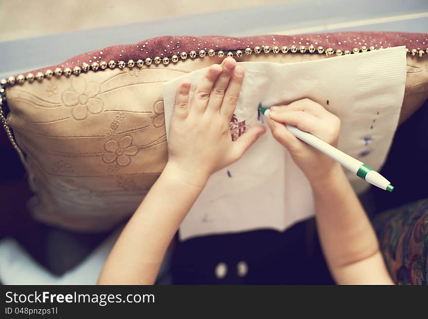 Girls in the restaurant drawing a picture on the tissue. Girls in the restaurant drawing a picture on the tissue