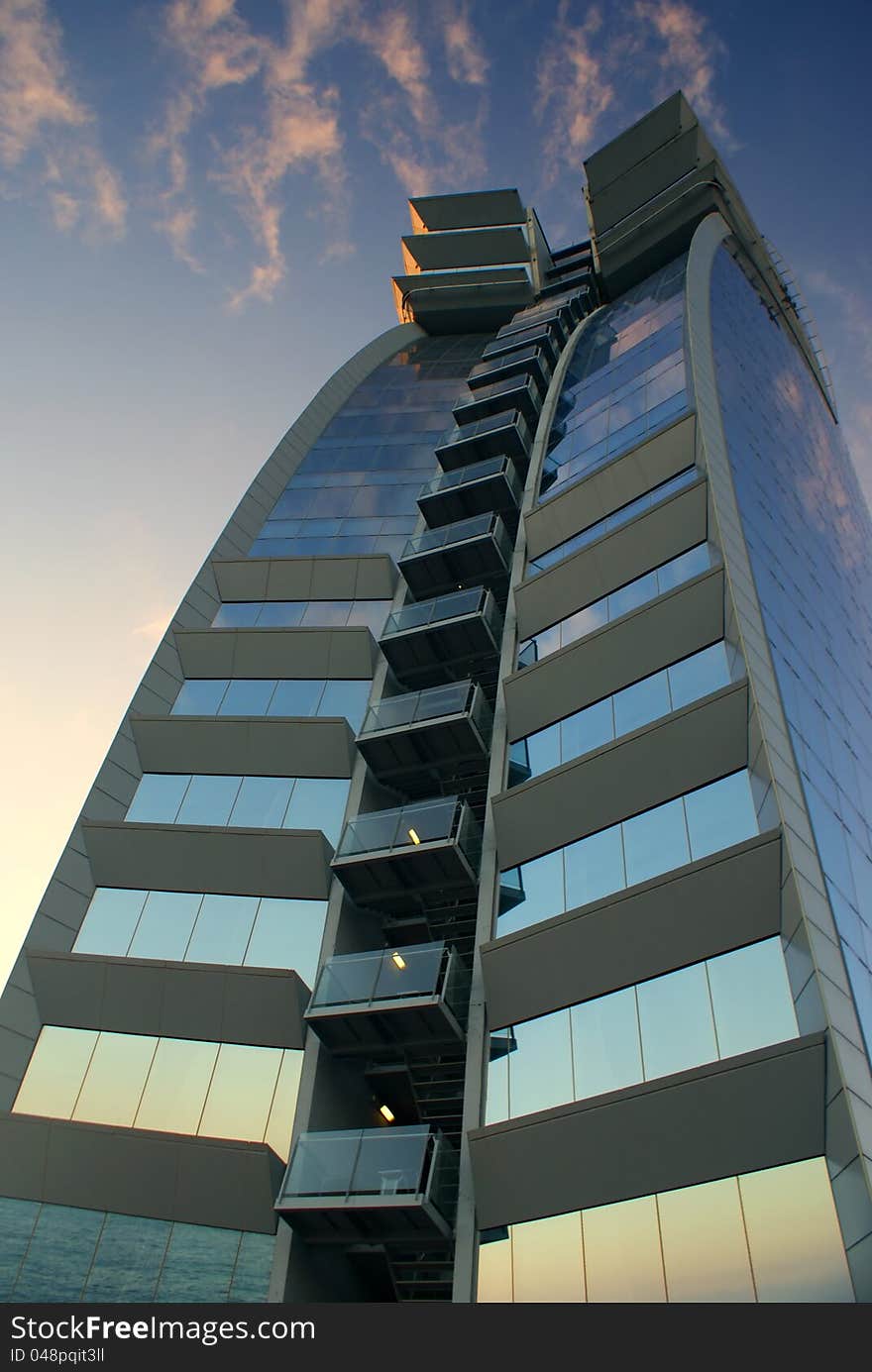 Modern Skyscraper in curve viewed from below. Modern Skyscraper in curve viewed from below.