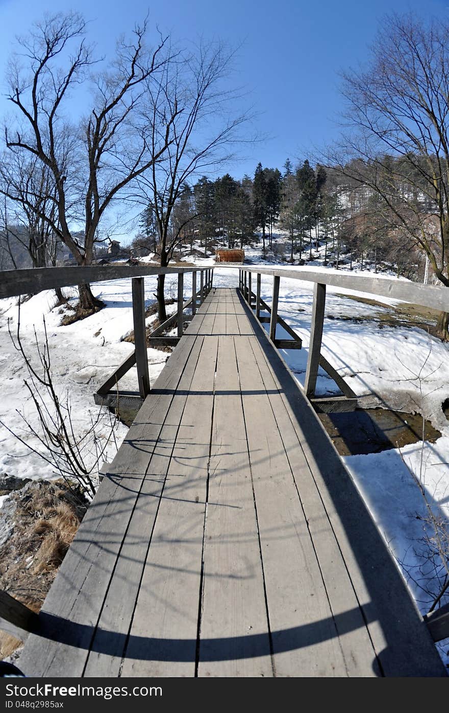 Wooden bridge mountain river