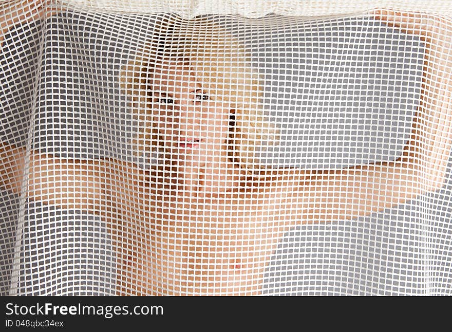 Nude Woman Looking Through Mesh Fabric