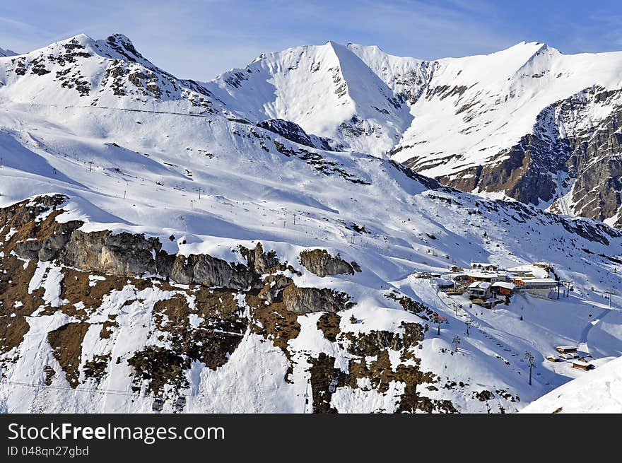 Zillertal Alps at Hintertux Glacier with a cable car station, ski lifts and pistes in sunset light. Zillertal Alps at Hintertux Glacier with a cable car station, ski lifts and pistes in sunset light