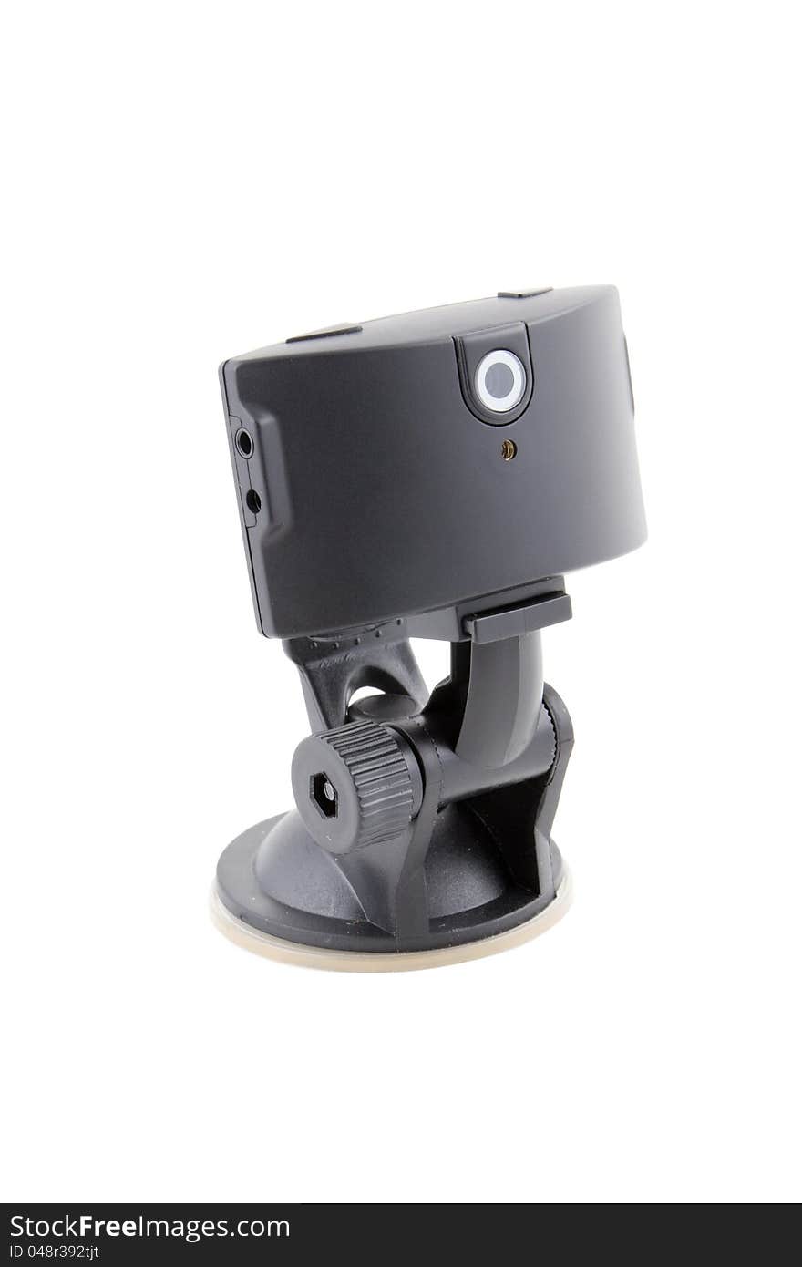 Car video recorder in black on the suction cup to the glass. Car video recorder in black on the suction cup to the glass