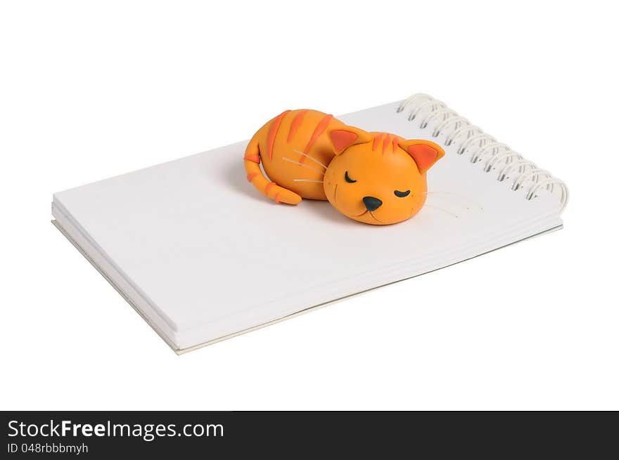 Sculpture cat napping on note book