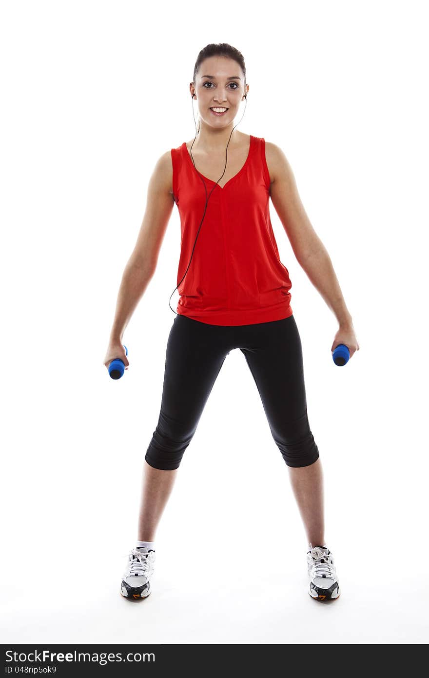 Young pretty fit woman exercising with weights while listening music. Studio Isolated on white. High key. Young pretty fit woman exercising with weights while listening music. Studio Isolated on white. High key