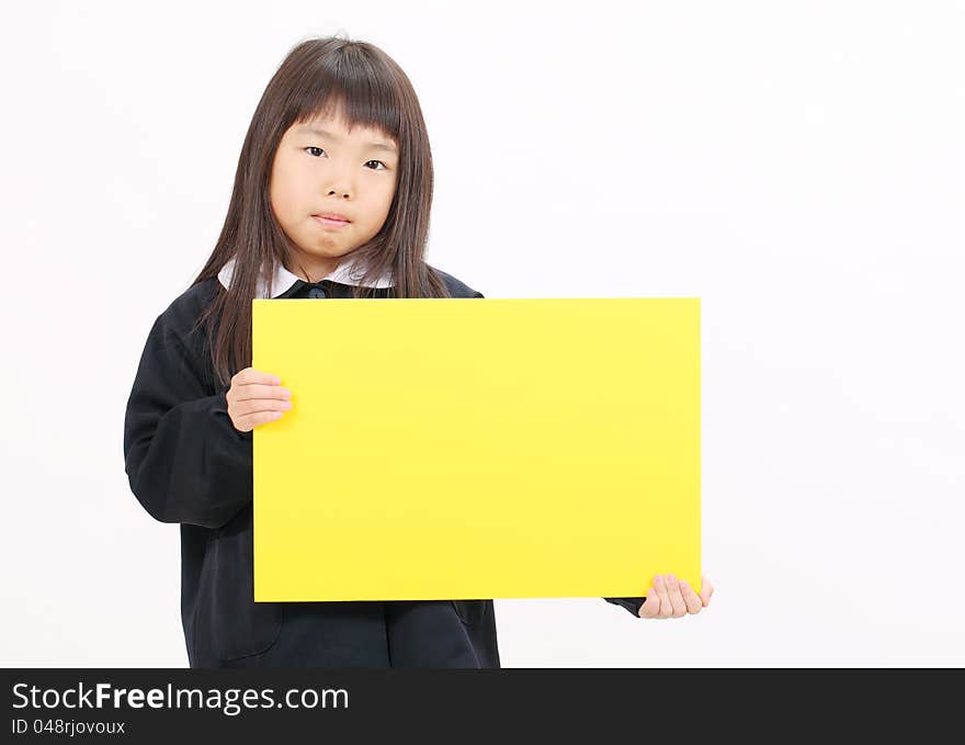 Little asian schoolgirl holding a blank board