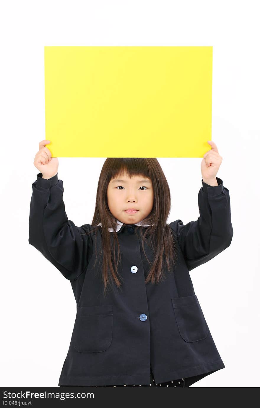 Little asian schoolgirl holding a blank board