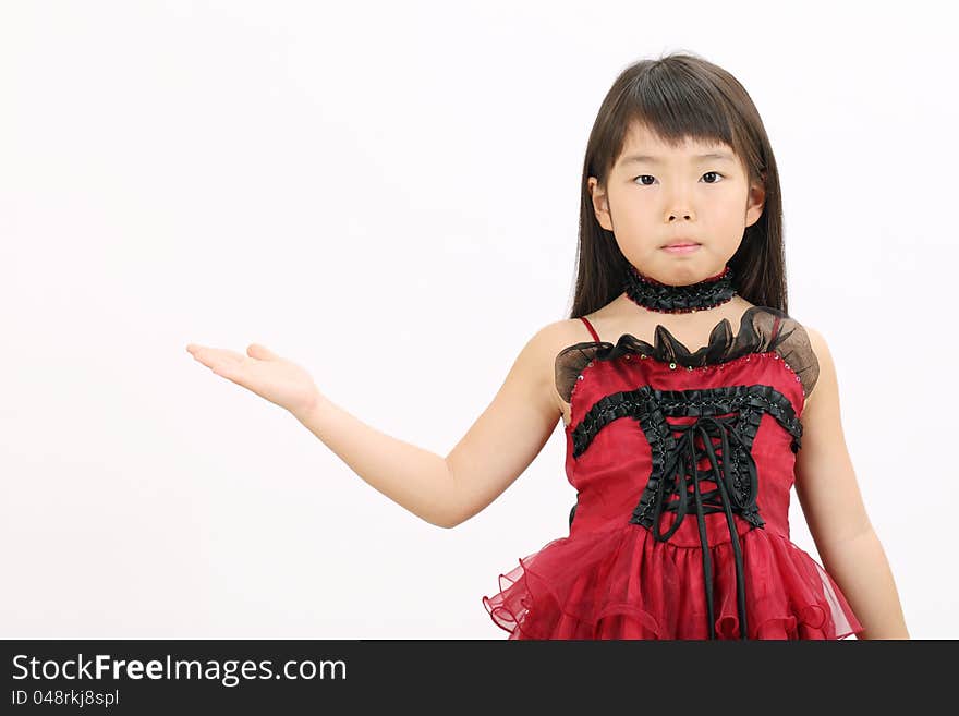 Little asian girl wearing dress, showing blank sign