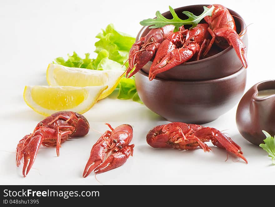 Boiled crawfish with lemon and fresh salad